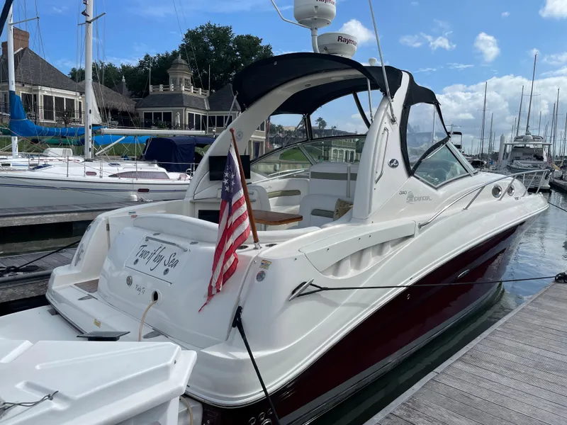 Slide: The Image of 2006 Sea Ray 320 Sundancer docked at marina with American flag. - 8