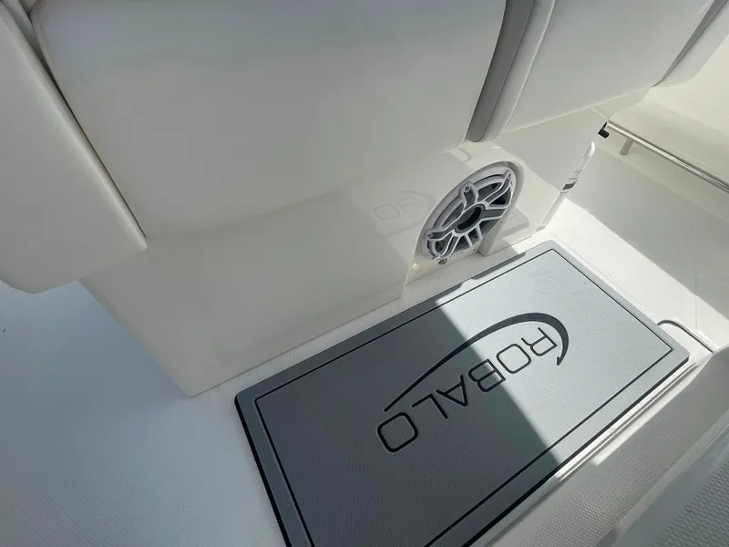 Slide: The Image of 2023 Robalo R270 boat interior with branded mat and speaker. - 15