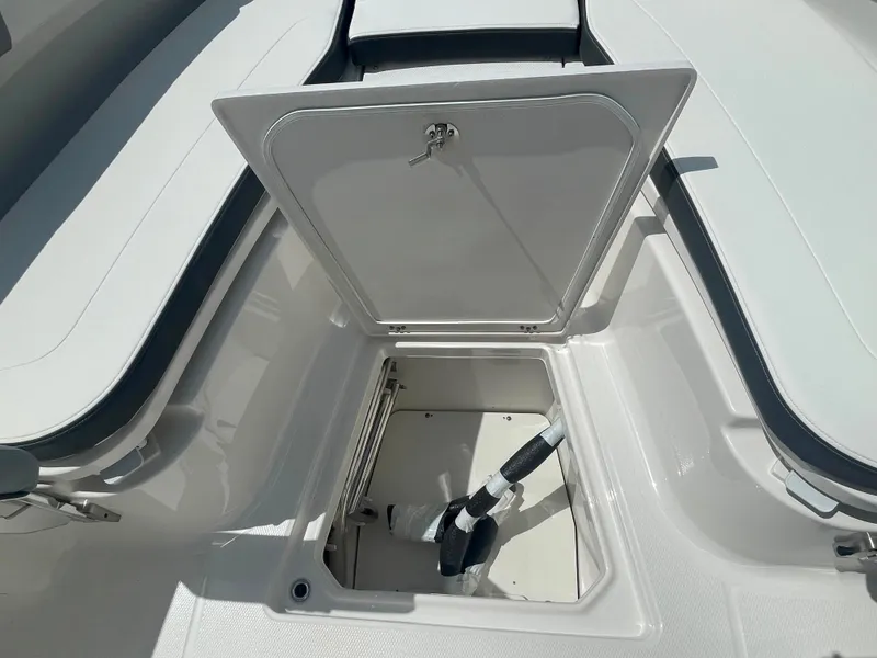 Slide: The Image of 2023 Robalo R270 storage compartment with open hatch. - 25