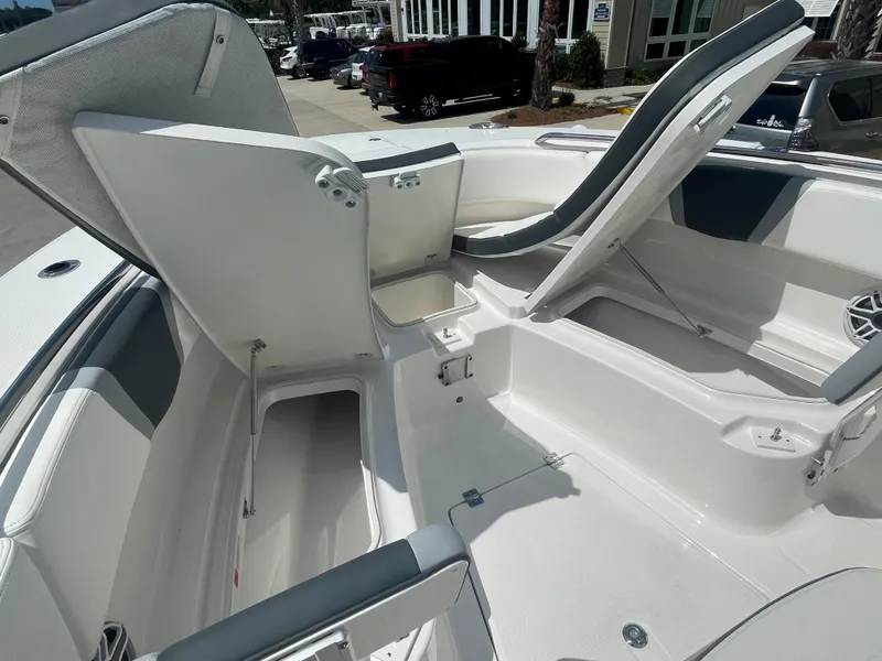 Slide: The Image of 2023 Robalo R270 boat interior with open storage compartments. - 23