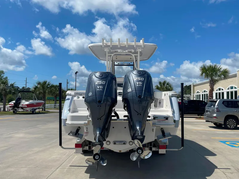 Slide: The Image of 2023 Robalo R270 boat with twin 250 V6 engines, parked on a sunny day. - 4
