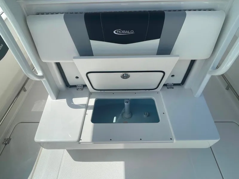 Slide: The Image of 2023 Robalo R270 boat interior with storage compartment and seating. - 8
