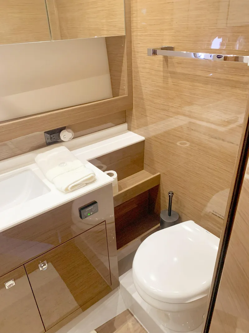 Slide: The Image of 2018 Cruisers Yachts CANTIUS 54 bathroom with modern fixtures and wooden cabinetry. - 11