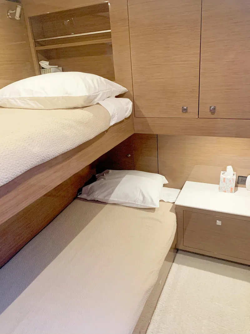 Slide: The Image of 2018 Cruisers Yachts CANTIUS 54 cabin with bunk beds and storage cabinets. - 14