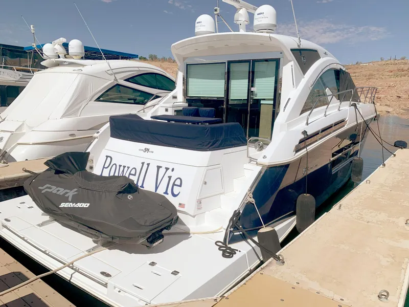 Slide: The Image of 2018 Cruisers Yachts CANTIUS 54 docked with a Sea-Doo jet ski on the platform. - 16