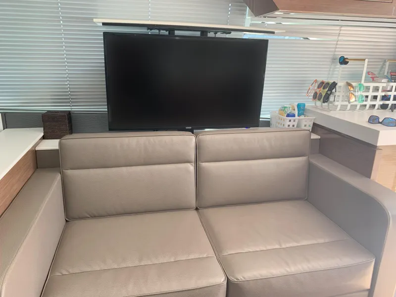 Slide: The Image of Interior of 2018 Cruisers Yachts CANTIUS 54 with sofa and TV. - 3