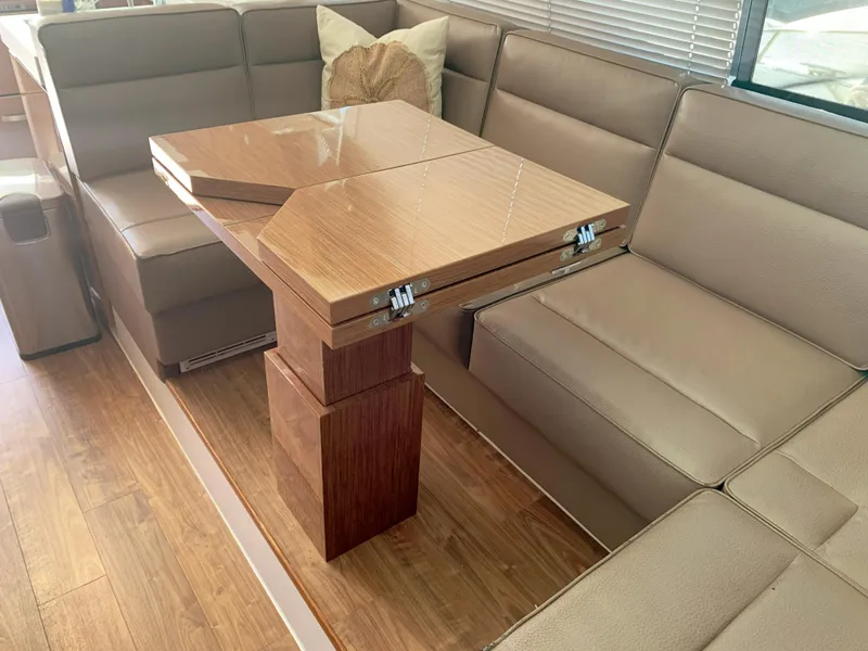 Slide: The Image of Luxurious seating area with a wooden table inside a 2018 Cruisers Yachts CANTIUS 54. - 4