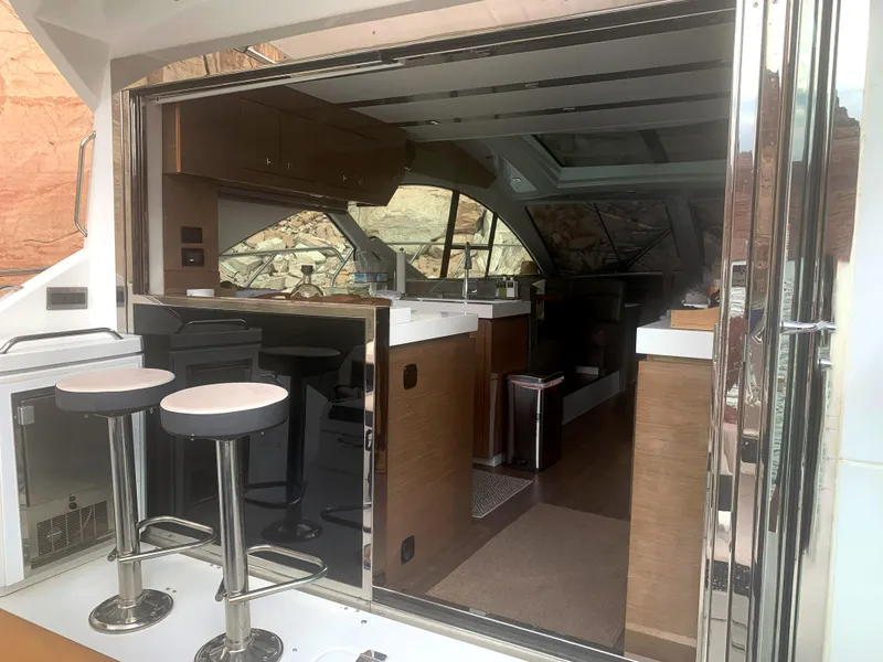 Slide: The Image of 2018 Cruisers Yachts CANTIUS 54 interior with modern kitchen and bar stools. - 5