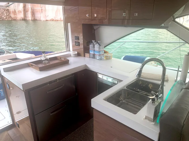Slide: The Image of Modern kitchen area on 2018 Cruisers Yachts CANTIUS 54, featuring sleek countertops and stainless steel sink. - 6