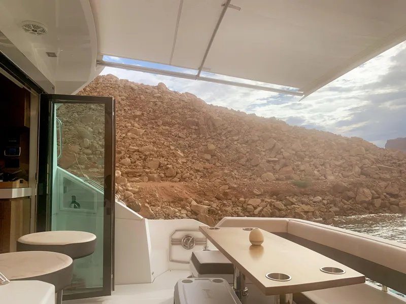 Slide: The Image of 2018 Cruisers Yachts CANTIUS 54 interior with scenic rocky landscape view. - 7