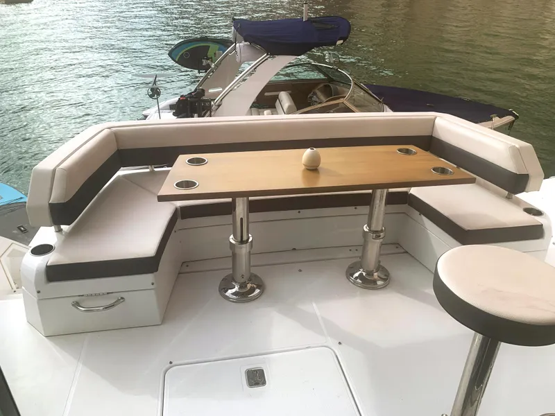 Slide: The Image of 2018 Cruisers Yachts CANTIUS 54 deck with seating and table, docked on water. - 9
