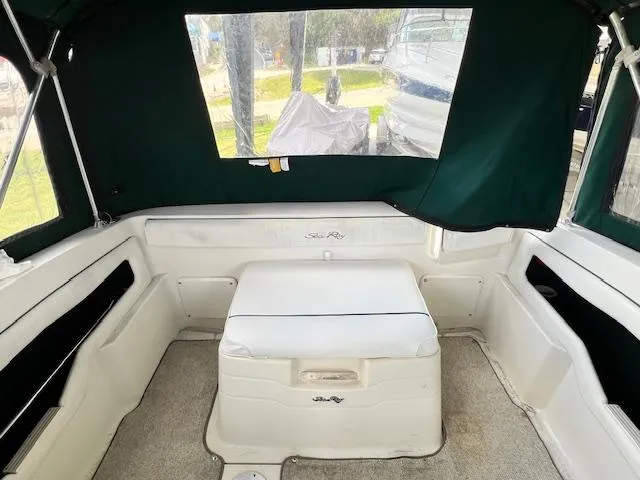 Slide: The Image of 1999 Sea Ray 215 Express Cruiser interior with seating and storage. - 4