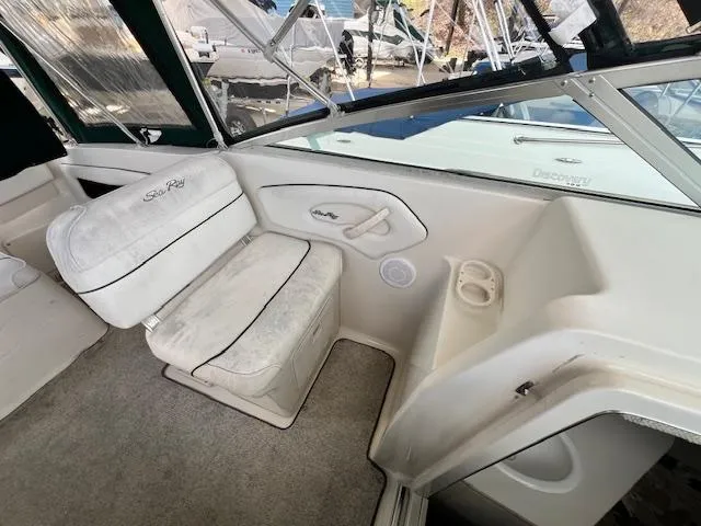 Slide: The Image of 1999 Sea Ray 215 Express Cruiser interior seating and dashboard area. - 6