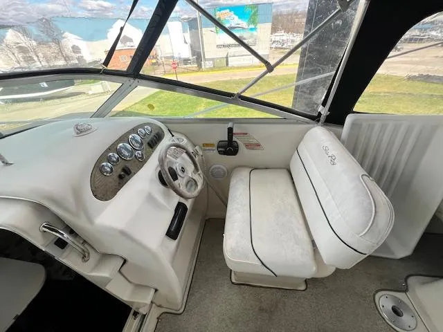 Slide: The Image of 1999 Sea Ray 215 Express Cruiser helm and seating area. - 8