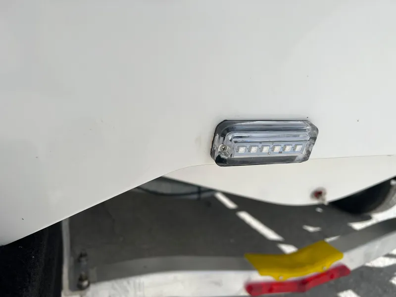 Slide: The Image of Close-up of a 2024 Clearwater 2200 boat's LED light on the hull. - 25