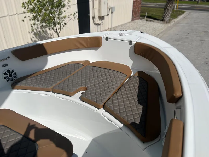 Slide: The Image of 2024 Clearwater 2200 boat with brown and gray cushioned seating. - 27