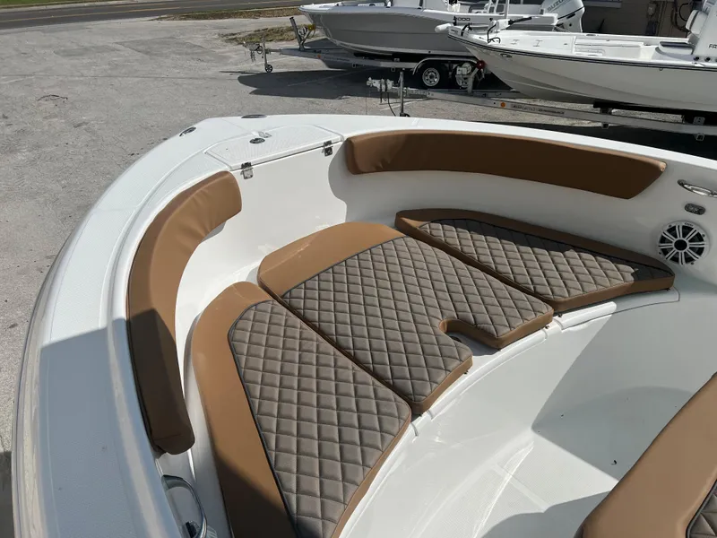 Slide: The Image of 2024 Clearwater 2200 boat with cushioned seating and diamond-stitched upholstery. - 28