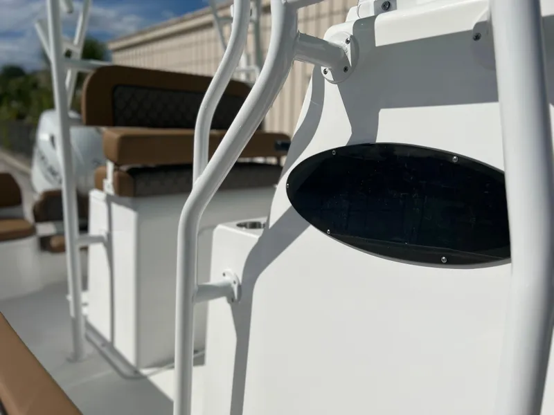 Slide: The Image of 2024 Clearwater 2200 boat interior with white and brown seating, close-up view. - 30