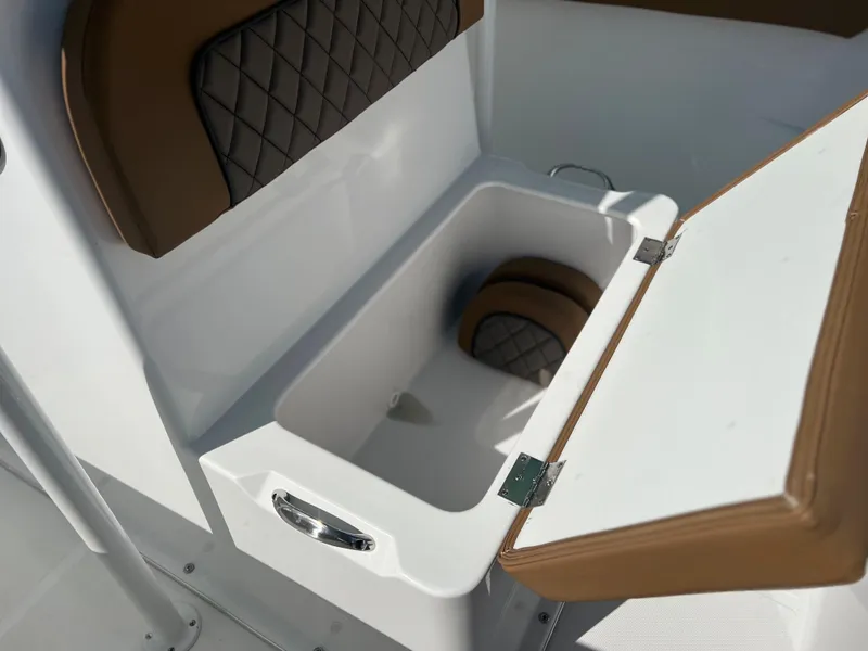 Slide: The Image of Clearwater 2200 2024 model boat storage compartment with cushioned seating. - 32