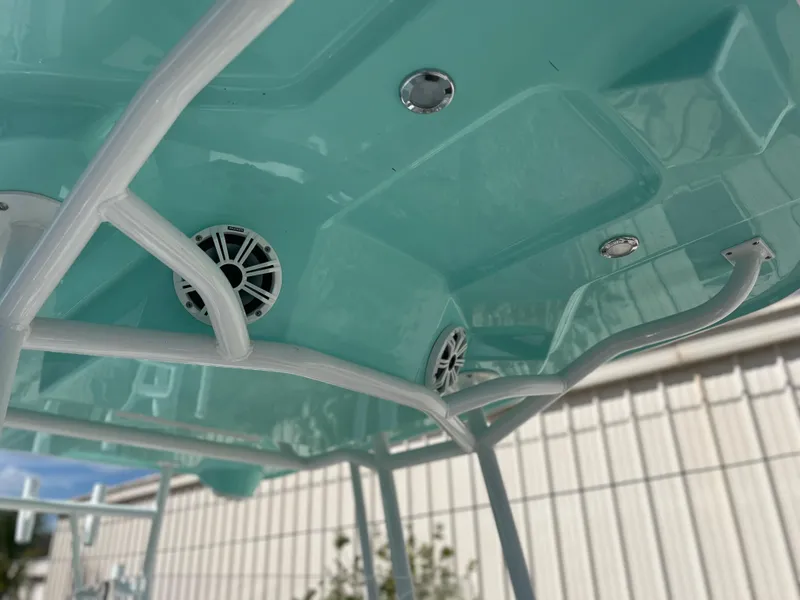 Slide: The Image of Clearwater 2200 2024 boat interior with teal ceiling and built-in speakers. - 33