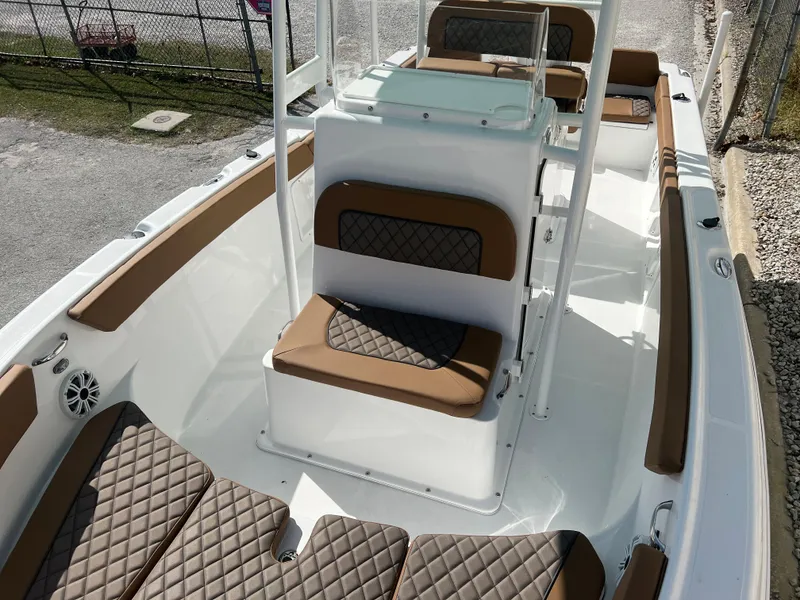 Slide: The Image of 2024 Clearwater 2200 boat interior with brown diamond-stitched seating and white deck. - 38