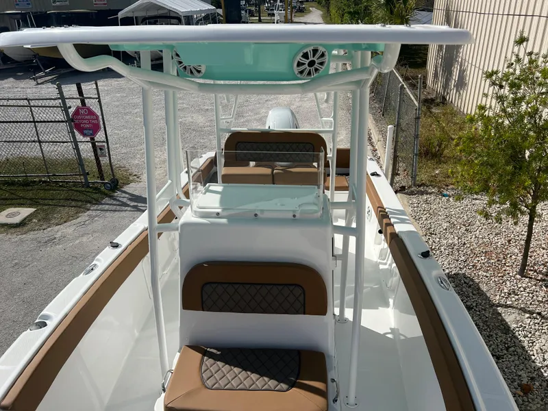 Slide: The Image of 2024 Clearwater 2200 boat with brown and white seating, overhead speakers, and center console. - 39