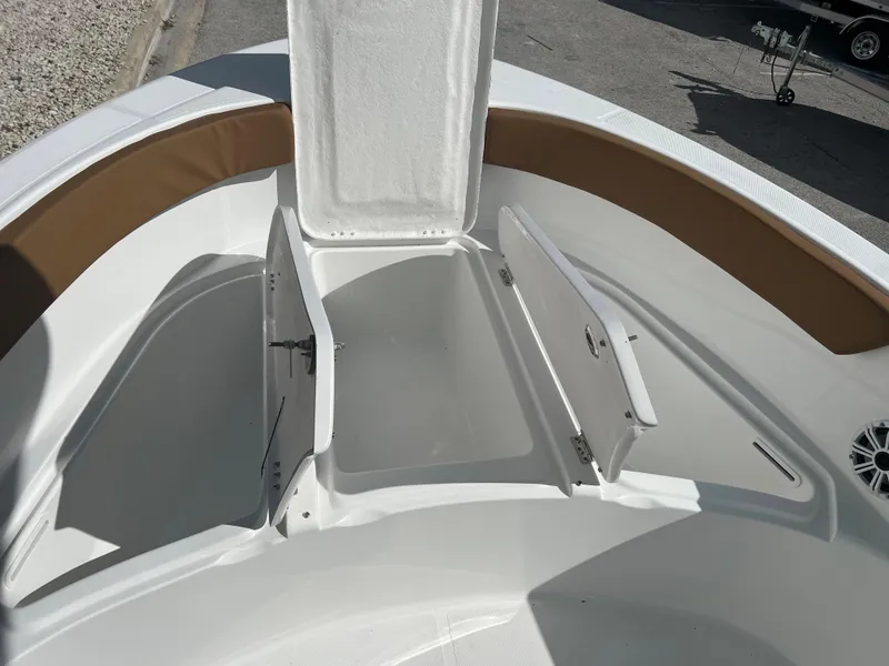 Slide: The Image of 2024 Clearwater 2200 boat with open storage compartments and brown cushioned seating. - 41