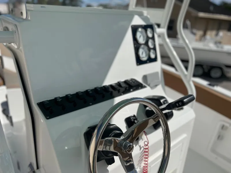 Slide: The Image of Clearwater 2200 2024 boat dashboard with steering wheel and control panel. - 45