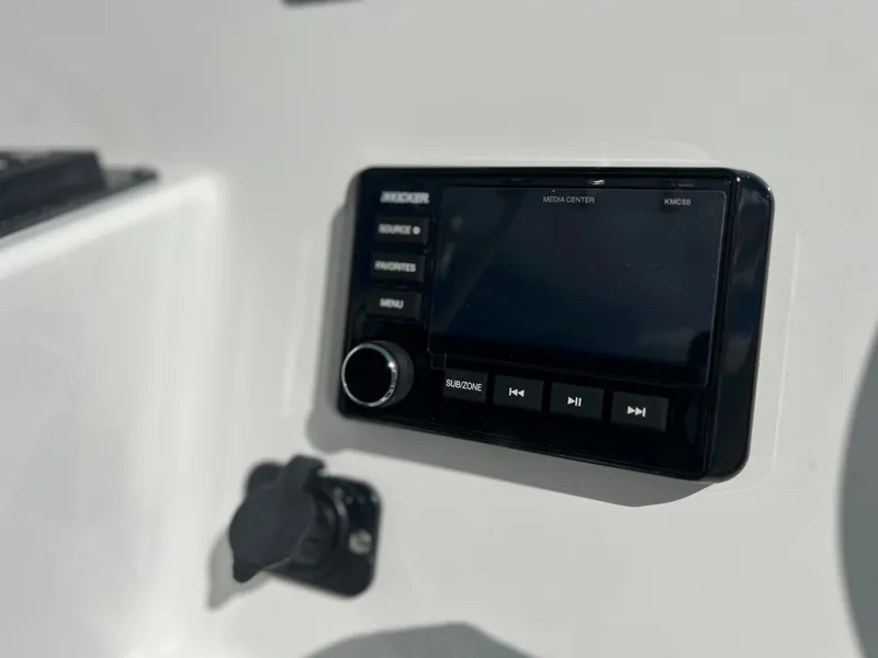 Slide: The Image of Close-up of the 2024 Clearwater 2200 boat's control panel and audio system. - 47