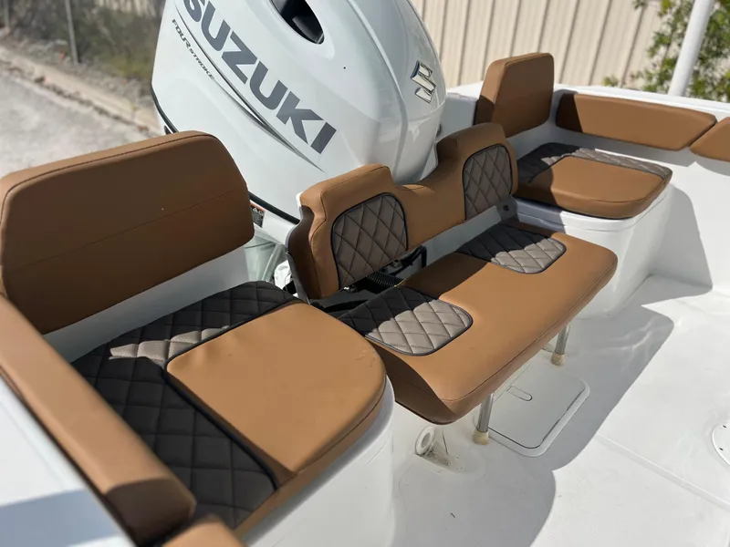 Slide: The Image of Clearwater 2200 boat 2024 model with Suzuki engine and brown cushioned seating. - 48