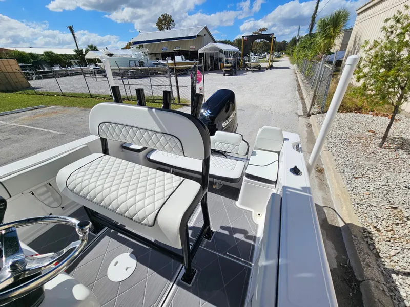 Slide: The Image of Clearwater 2000 boat 2023 model, white interior, docked at marina under blue sky. - 12