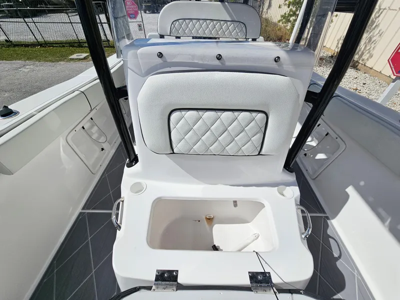 Slide: The Image of Clearwater 2000 boat interior, 2023 model, featuring cushioned seating and storage compartment. - 15