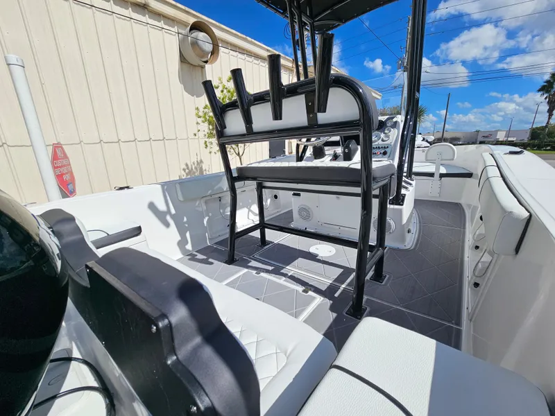Slide: The Image of Clearwater 2000 boat interior, 2023 model, featuring seating and console under a clear blue sky. - 18