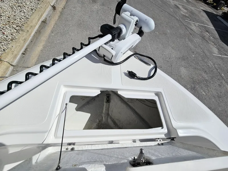 Slide: The Image of Clearwater 2000 boat bow with open storage compartment and trolling motor, 2023 model. - 26