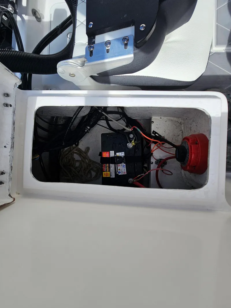 Slide: The Image of Battery compartment of a 2023 Clearwater 2000 boat with wiring and components. - 28
