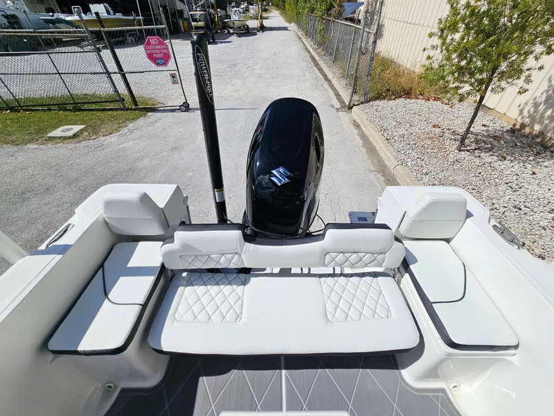 Slide: The Image of Clearwater 2000 boat 2023 model with white cushioned seating and Suzuki outboard motor. - 3