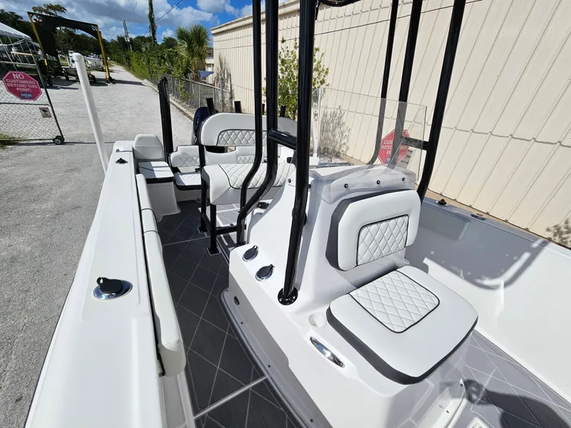 Slide: The Image of 2023 Clearwater 2000 boat interior with white cushioned seats and black frame. - 33