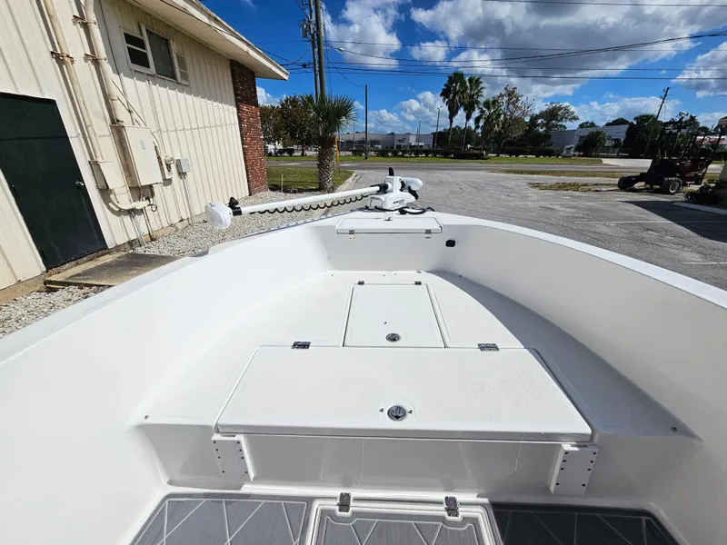 Slide: The Image of Clearwater 2000 boat, 2023 model, white interior, docked outdoors under a blue sky. - 35