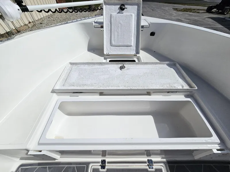 Slide: The Image of Clearwater 2000 boat 2023 model with open storage compartments and clean white interior. - 37