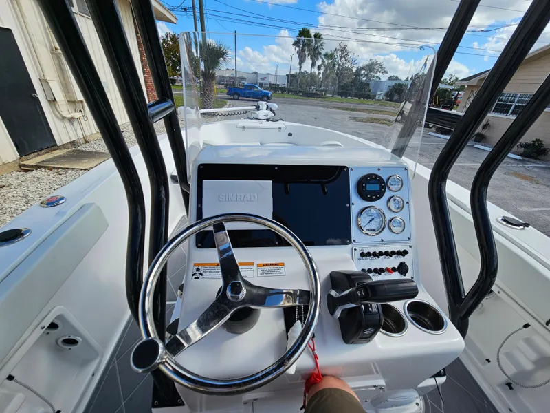 Slide: The Image of Clearwater 2000 boat dashboard, steering wheel, and controls, 2023 model. - 38