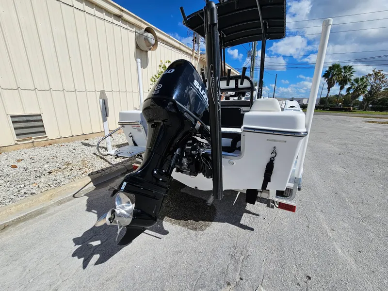 Slide: The Image of Clearwater 2000 boat, 2023 model, with outboard motor, parked outdoors. - 9