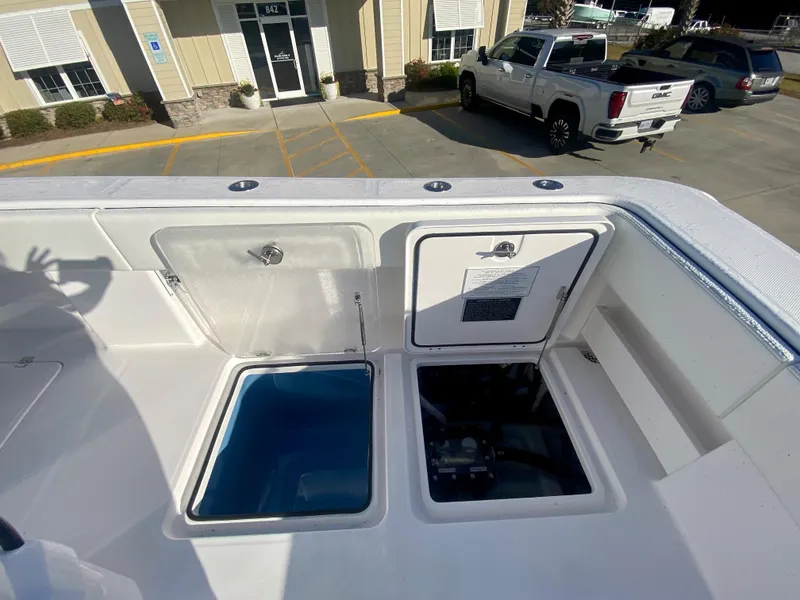 Slide: The Image of 2024 Invincible 35 Catamaran storage compartments and livewell on deck. - 10