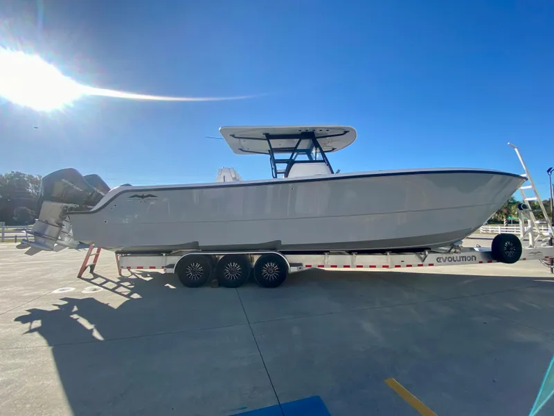 Slide: The Image of 2024 Invincible 35 Catamaran on trailer under clear blue sky. - 3