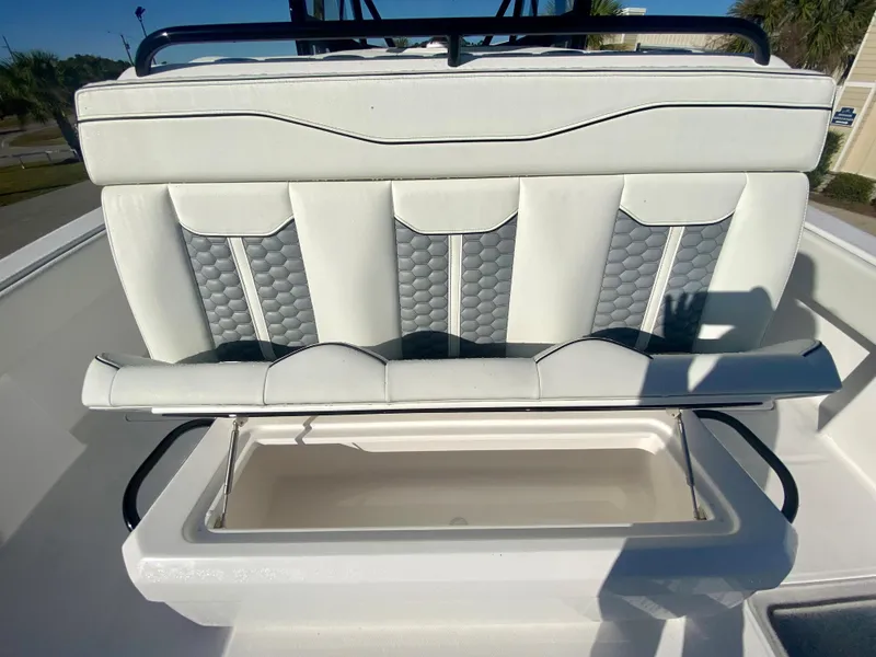 Slide: The Image of 2024 Invincible 35 Catamaran with open storage compartment and cushioned seating. - 12