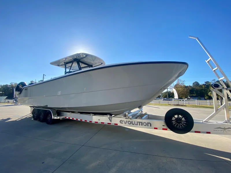 Slide: The Image of 2024 Invincible 35 Catamaran on trailer, side view, sunny day. - 2