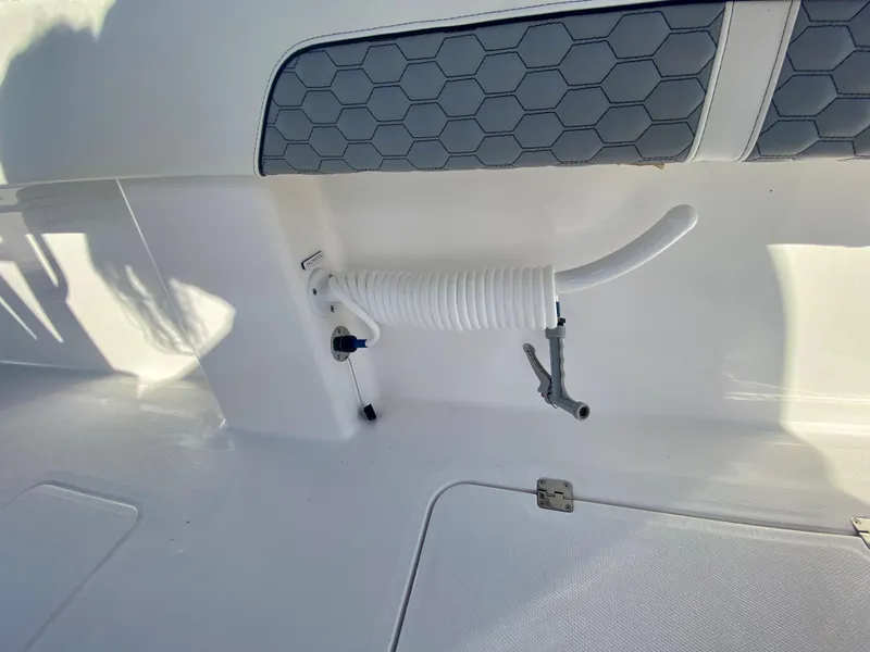 Slide: The Image of 2024 Invincible 35 Catamaran deck with coiled hose and hexagonal seat pattern. - 22