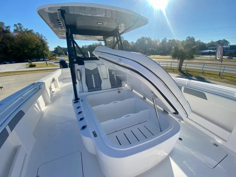 Slide: The Image of 2024 Invincible 35 Catamaran with open storage compartment and seating area. - 26