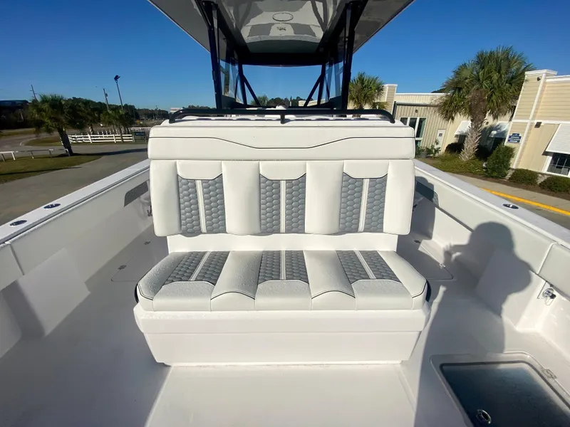 Slide: The Image of 2024 Invincible 35 Catamaran with cushioned seating and modern design. - 11