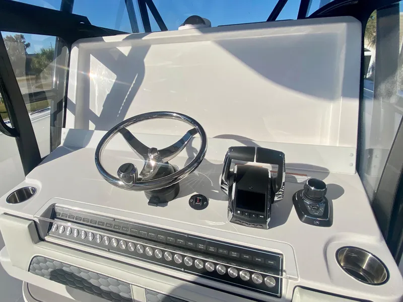Slide: The Image of 2024 Invincible 35 Catamaran helm with steering wheel and controls. - 18