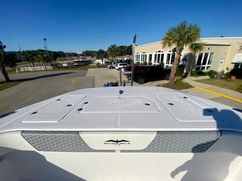 Slide: The Image of 2024 Invincible 35 Catamaran at dock with palm trees and vehicles in background. - 27